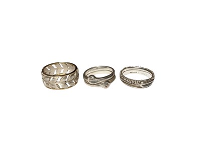 Lot 34 - Contemporary silver and 18ct gold pierced leaf design ring and two other silver rings, all the same maker EJS.