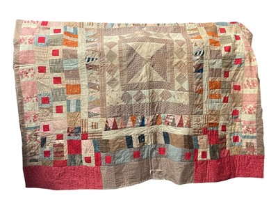 Lot 2580 - Victorian patchwork quilt constructed with squares and triangles. Later replacement stripe cotton lining machine stitched in squares. Wool wadding as middle layer. 180 cm x 200 cm.