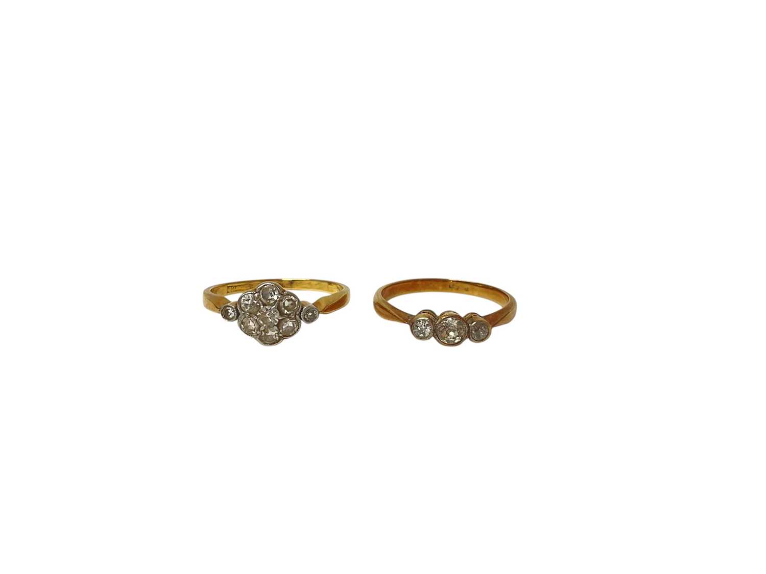 Lot 54 - 18ct gold diamond flower head cluster ring and 18ct gold diamond three stone ring (2)