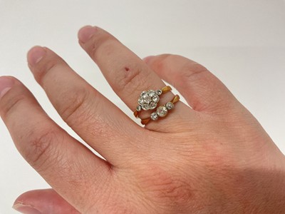 Lot 54 - 18ct gold diamond flower head cluster ring and 18ct gold diamond three stone ring (2)