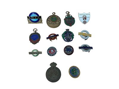 Lot Group of fourteen vintage London Transport enamel fobs and badges to include an Old Comrades Association badge and sports club fobs, (14).