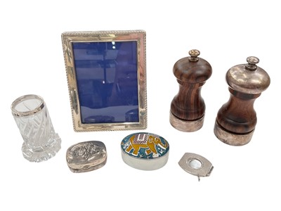 Lot 125 - Two silver mounted turned wood salt and pepper mills, silver photograph frame, silver cigar cutter, silver trinket box, plated enamelled pot and a silver mounted glass vase