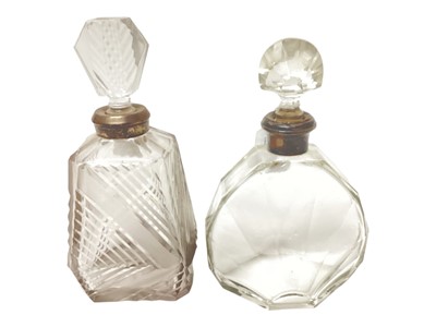 Lot 2242 - Art Deco French silver mounted cut glass decanter, the body modelled in the sun burst style with faceted decoration, together with another Art Deco cut glass decanter, with white metal mount, (2...