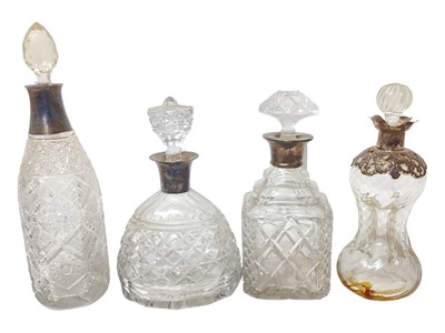 Lot 2244 - Group of four Edwardian and later silver mounted cut glass decanters, (various dates and makers), (4).