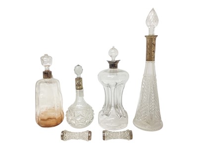 Lot 2245 - Group of four silver mounted cut glass decanters, together with a pair of silver mounted cut glass knife rests, (various dates and makers), (6).