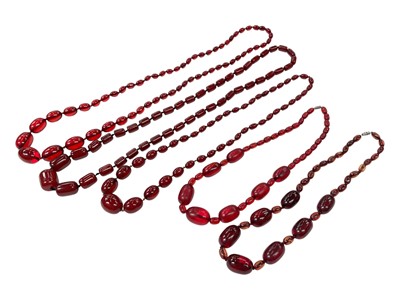 Lot 167 - Five vintage simulated cherry amber polished bead necklaces, various sizes