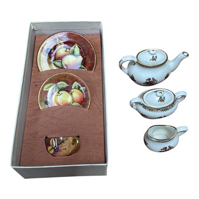 Lot 5044 - Coalport miniature porcelain trio hand painted with fruit, together with another Coalport miniature teaset 'Ming Rose'