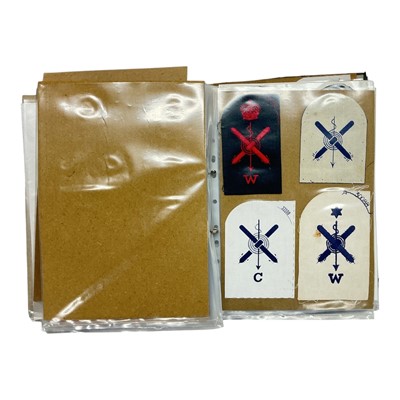 Lot 747 - Collection of mainly Royal Navy cloth badges, contained within a ring binder album.