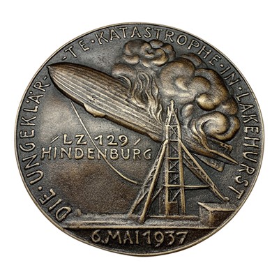 Lot 675 - Germany - A bronze medallion commemorating The Hindenburg Disaster Zepplin LZ 129, Obv: Portrait of Ernst A. Lehmann, Rev: Zepplin on fire, 6 May 1937 by K. Goetz (Dia:...