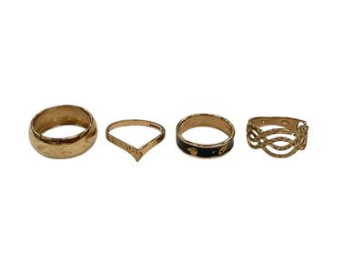 Lot 220 - Four 9ct gold rings to include a wedding band, size L½, wishbone ring, size N½, black enamel ring, size M and a pierced band ring, size M