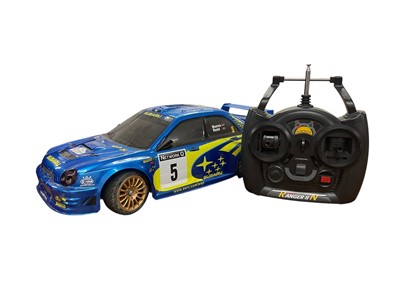 Lot 1943 - Remote control Subaru Racing Car with Techniplus controller both in carrying cases.