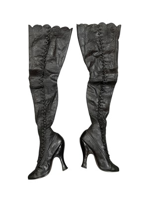 Lot 2598 - 19th Century black leather thigh-high button boots, with high waisted heel. Leather sole and leather heel. Possibly theatre or dance shoes.
