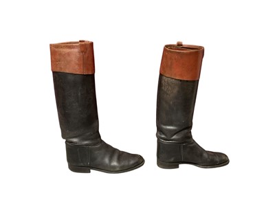 Lot 2599 - A pair of gentlemen's black leather riding boots with tan leather tops. Plus a pair of boot trees by Faulkner & Son.