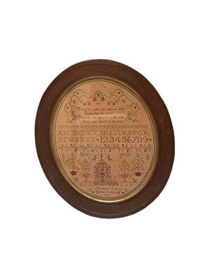 Lot 2601 - Large oval sampler by Margaret Simcock, aged 11 years. Includes scrolling flowers, church, potted plants, alphabet and numerals. Framed and glazed. Overall frame measures approx 64cm x 56cm.
