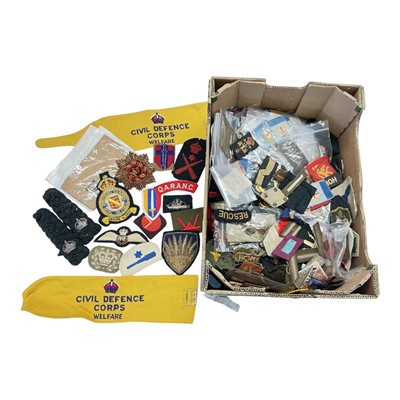 Lot 806 - Group of assorted cloth military badges, naval cap tallies, Civil Defence arm band and other items, (1 box).