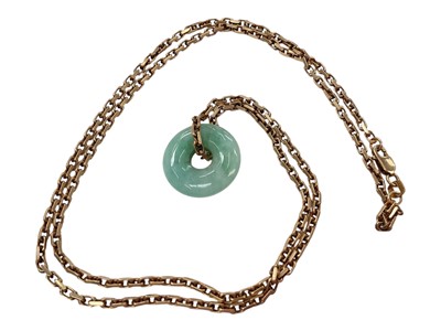 Lot 948 - Chinese jade / green hardstone disc pendant on 9ct gold chain