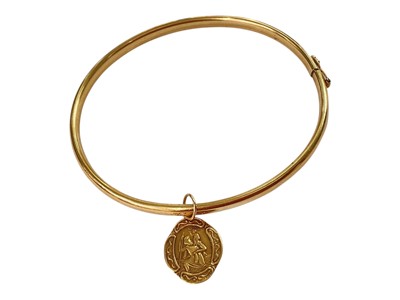 Lot 243 - 9ct gold bangle with 9ct gold St. Christopher pendant