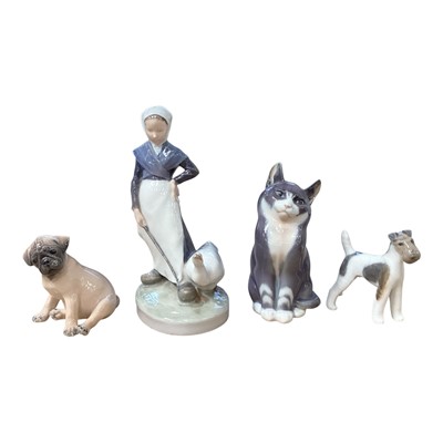 Lot 2289 - Four Royal Copenhagen ornaments to include a lady with a goose number 528, a cat number 115 and two dogs number 3169 and 3170