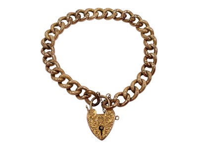 Lot 262 - 9ct gold curb link bracelet with padlock clasp and engraved decoration