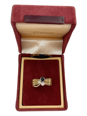Lot 1019 - Sapphire and diamond three stone ring, stamped 750