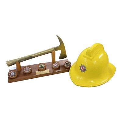 Lot 877 - Fire Brigade interest- fire axe, mounted on presentation stand, mounted with various fire service badges and presentation plaque from West Midlands Fire Service to Sub. Officer S. Ovens, 1953 -...
