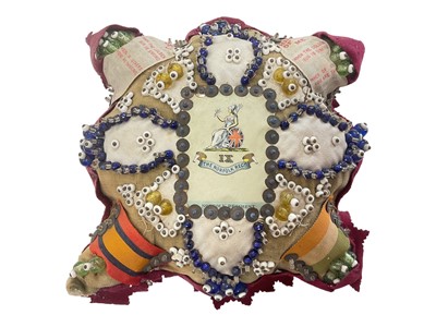 Lot 920 - First World War Norfolk Regiment Sweetheart pin cushion, mounted with beads, Queen's and King's South Africa medal ribbons and silks.