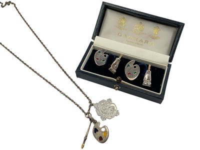 Lot 900 - Pair of novelty silver and enamel artist's paint palette and tube cufflinks (Sheffield import mark 1995), by Garrard & Co Ltd, boxed, together with a similar silver Links of London charm on chain