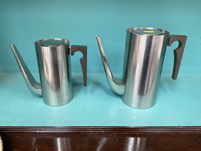 Lot 5058 - Two Midcentury Danish Stelton Cylinda stainless steel coffee pots, designed by Arne Jacobsen, 17cm and 20cm high