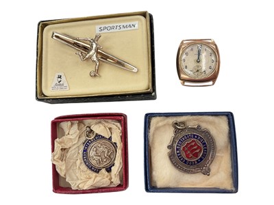 Lot 944 - 1940s 9ct gold cased Record watch, together with two white metal and enamel football fobs and a football tie clip (4)