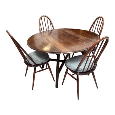 Lot 5345 - Ercol dark elm drop leaf table together with four matching Ercol chairs