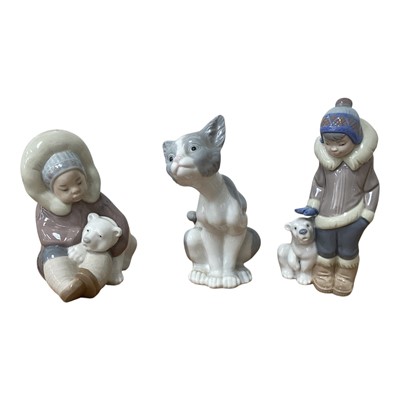 Lot 5053 - Two Lladro figures of eskimos and a Lladro cat (3)