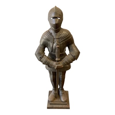 Lot 5163 - Cast metal knight holding a toasting fork and poker, 66cm high