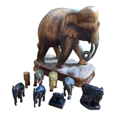 Lot 5129 - Large carved wooden elephant and a group of smaller elephants