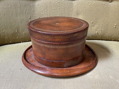 Lot 5191 - Unusual leather box in the form of a top hat, with gilt tooling, marked 'Maitland-Smith' to the base, 30cm long x 14cm high