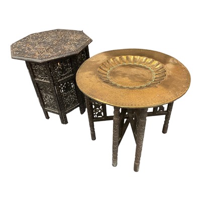 Lot 1301 - Two Islamic side tables, including tooled brass topped table and a carved collapsible table