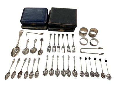 Lot 1029 - Three sets of six silver tea/coffee spoons, set of six silver cake forks, all with fitted cases, together with other silver flatware and four silver napkins rings