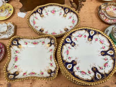 Lot 14 - Late Victorian / Edwardian Wedgwood dessert service, printed and painted with swags of roses, on a cobalt blue and gilt pattered ground, comprising two oval dishes, two square dishes, and twelve...