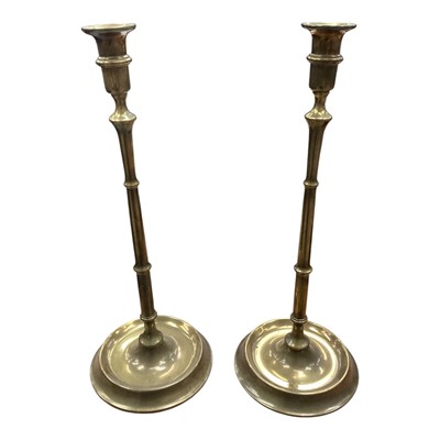 Lot 27 - Pair of antique brass tall candlesticks with turned columns on circular bases