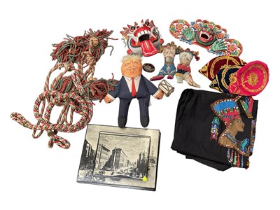 Lot 17 - Sundry items, including two Indonesian carved and painted wood masks, embroideries, a Donald Trump doll, and a group of placemats