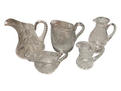 Lot 314 - Five Georgian and later cut glass jugs