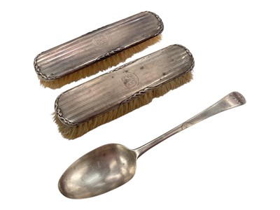 Lot 991 - Georgian silver table spoon and a pair of silver backed brushes (3)