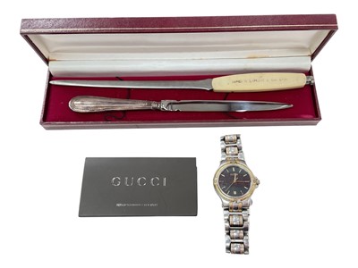 Lot 1005 - Gucci stainless steel wristwatch with booklet, together with a silver handled letter opener and another letter opener (3)