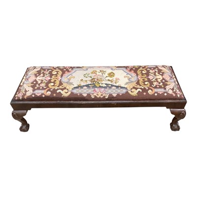 Lot 1376 - Long mahogany framed footstool with tapestry top on carved cabriole legs with claw and ball feet, 90cm long, 25cm high