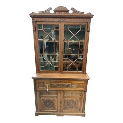 Lot 1378 - Late Victorian/Edwardian two height carved walnut secretaire bookcase with astragal glazed doors above, fitted interior and two carved panelled doors below, 123cm wide, 52cm deep, 239cm high app...