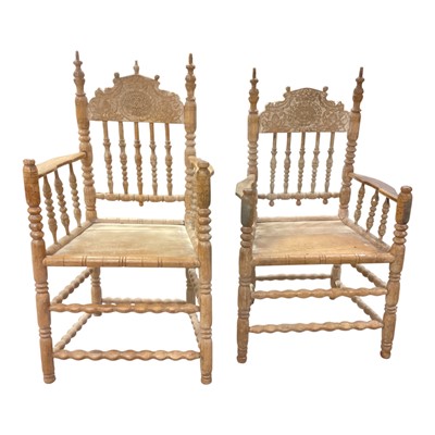 Lot 1383 - Two early 19th century continental bobbin turned elbow chairs with spindle backs and carved cresting dated 1819