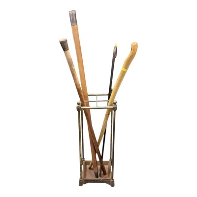 Lot 1445 - Late Victorian brass stick stand containing four sticks