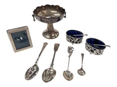 Lot 940 - Pair of silver salts with pierced floral decoration with salt spoons, silver pedestal dish with swing handles, miniature silver photograph frame and four silver spoons