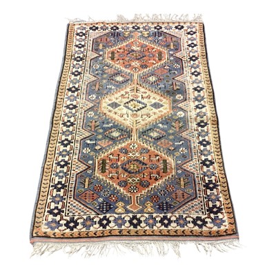 Lot 1419 - Eastern rug with three central medallions on cream, blue and red ground, 126cm x 75cm