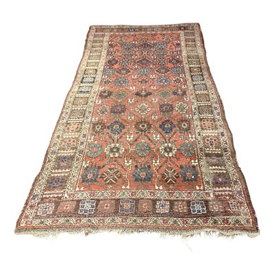 Lot 1420 - Eastern rug with geometric decoration on red, blue and beige ground, 276cm x 129cm