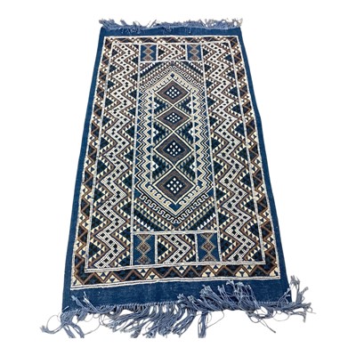 Lot 1426 - Small rug with geometric decoration on blue ground, 144cm x 71cm